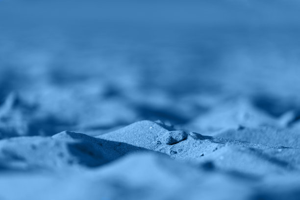 纹理砂背景。特写镜头的沙子。夏日海滩的图案图片下载