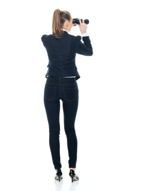 后视图/后/全身/正面视图/看相机/一个20-29岁的成年人漂亮的棕色头发/马尾辫高加索女性/年轻女性商人/女商人站着谁在寻找与手并排图片下载