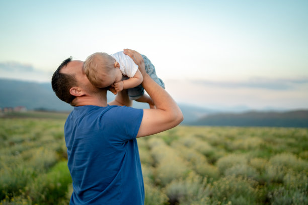 家庭时间。父亲抱着一个小儿子。春天走了图片下载
