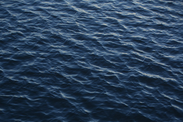 蓝色到黑色阴影的水团图片。波浪的精细结构。无限的背景水波浪在湖中。自然的纹理。图片下载
