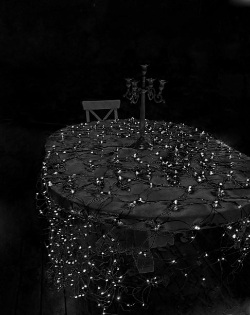 用圣诞彩灯装饰的花园桌子上的烛台图片下载