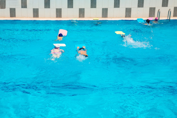 在游泳学校的游泳池里学习游泳的小孩子。儿童或青少年在游泳池进行训练和游泳比赛。图片下载