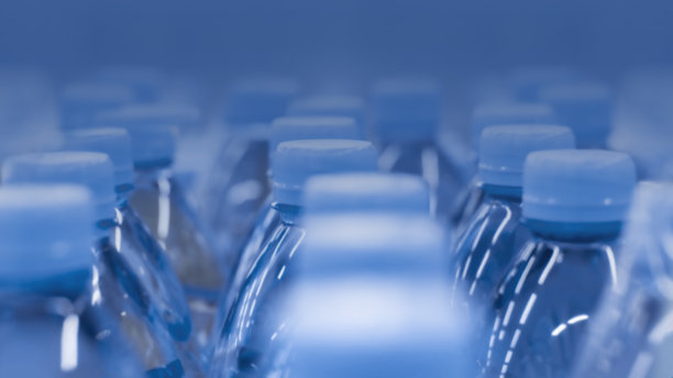 散焦背景塑料瓶的水。2020年的颜色经典的蓝色背景墙纸，照片色调在时尚的蓝色图片下载