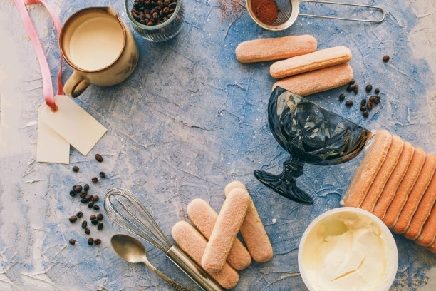 提拉米苏的烹饪概念，制作意大利甜点的配料在蓝色的桌子上，准备传统蛋糕的过程俯视图图片下载