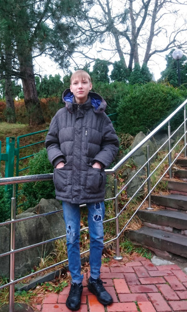 一个满头白发的少年在秋季公园散步图片下载