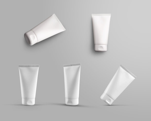 白色化妆管与一个帽子的模型在灰色背景与阴影。图片下载