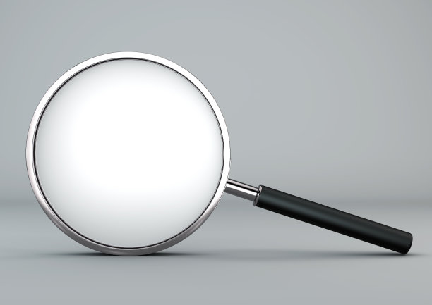 在灰色背景上的放大镜。图片下载