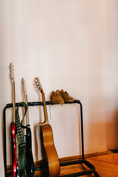 音乐乐器和服装的背景概念。皮革时尚男士鞋附近排原声吉他。复古,instagram。图片下载