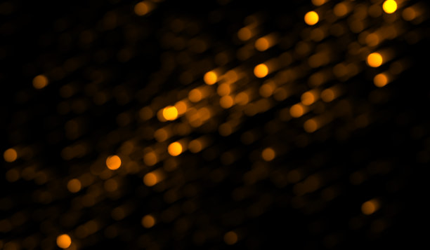 黑色上闪烁着金色的粒子图片下载