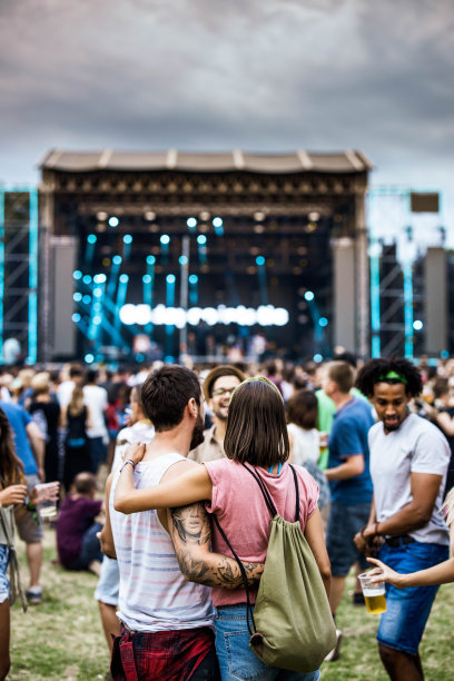 在音乐会上拥抱夫妇和他们的朋友的背影。图片下载
