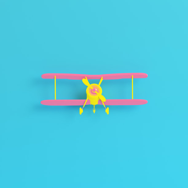 淡蓝色背景上的黄色双翼飞机。极简主义的概念图片下载