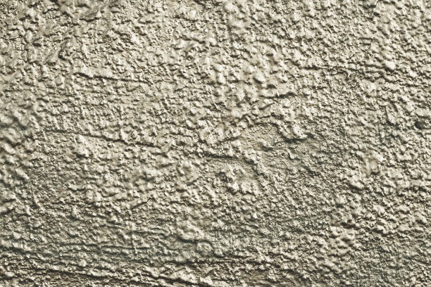 自然图案的油漆墙。绿色和灰色的混凝土表面。城市外部的纹理背景，灰泥。抽象闪亮的建筑背景，不均匀的建筑立面。图片下载