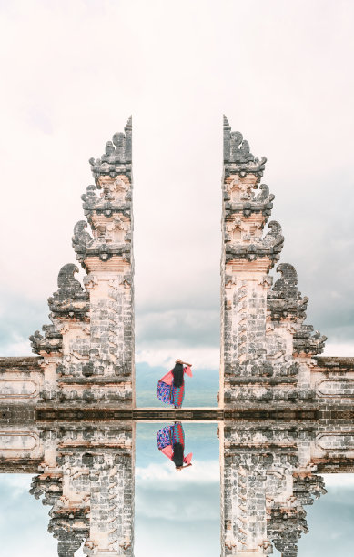 一个女孩在天门前摆姿势，倒影在水中。图片下载