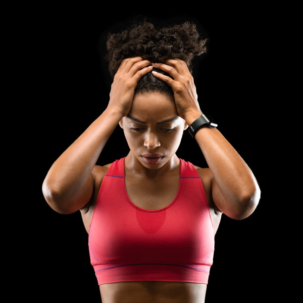 集中运动妇女在运动服装触摸她的头图片下载