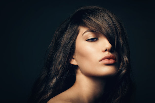 肖像非常美丽的年轻白人黑发女子模型与健康的头发额。图片下载