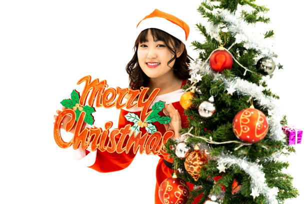 穿着圣诞老人服装和圣诞树的女人图片下载