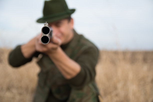 特写的一个步枪管与猎人持有它图片下载