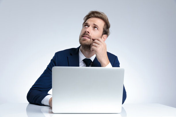 沉思的商人抬起头来，手放在脸颊上图片下载