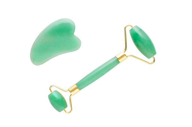 玉面滚轮和按摩石刮沙，孤立在白色背景上图片下载