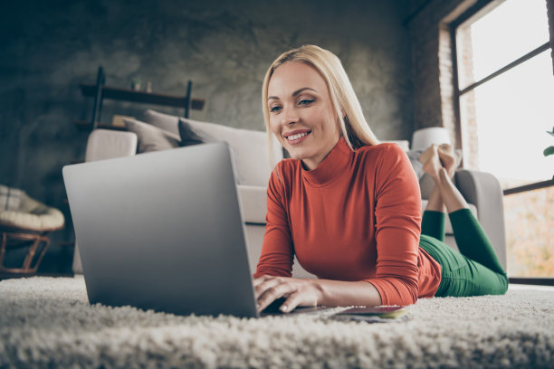 漂亮女士家的心情照片，工作的房子，写报告，笔记本，和朋友聊天，躺在沙发附近的地毯地板休闲装客厅室内图片下载
