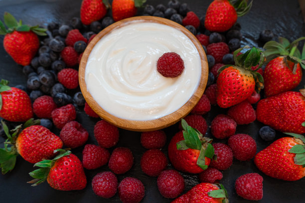 希腊酸奶碗和勺子，健康的早餐与新鲜的希腊酸奶，麦片和浆果的背景图片下载