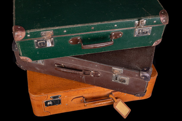 老摧毁了手提箱。长途旅行中使用的旅行箱黑暗的背景。图片下载