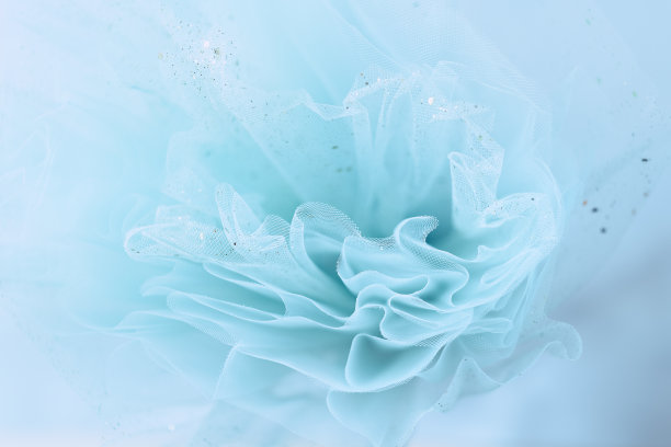 女性绿松石织物背景与金色闪光素材图片