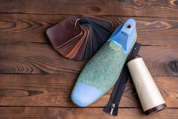 皮鞋和木鞋的皮革样品在深色的木桌上。图片下载