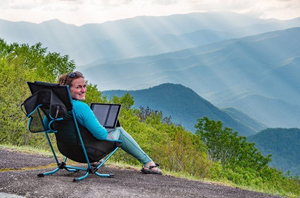 在平板电脑上工作的女性会回头微笑图片下载