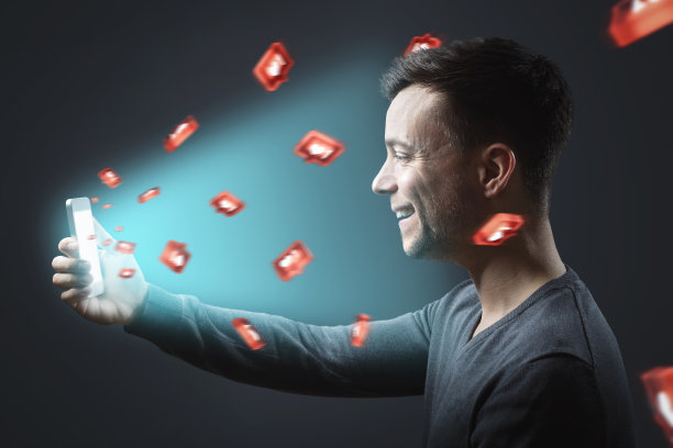 拿着智能手机的快乐男人在社交媒体上得到了很多赞图片下载