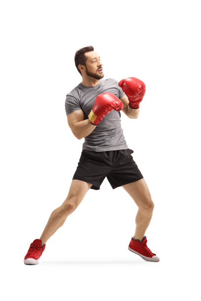 戴拳击手套的年轻人站在防守位置图片下载