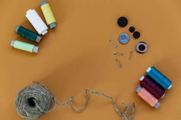 一组平躺在彩色背景上的缝纫物品。水平背景广告或包装。图片下载