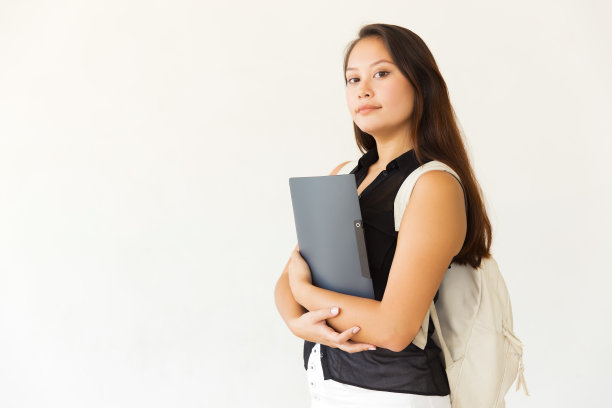认真的女学生与文件夹和背包图片下载