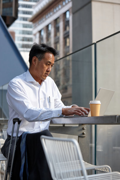澳大利亚商人在外面用笔记本电脑工作图片下载