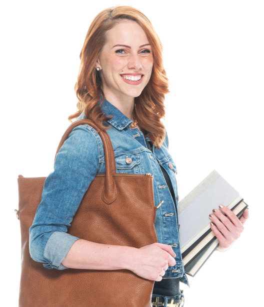 白人女学生穿着牛仔夹克，拿着课本图片下载