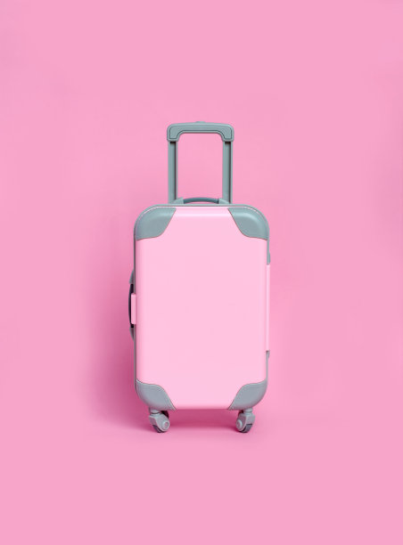 粉红色底色的粉红色手提箱。极简主义图片下载