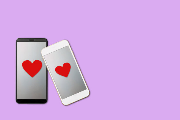 情人节概念，两个智能手机的红色心形屏幕上，孤立在紫色的背景图片下载