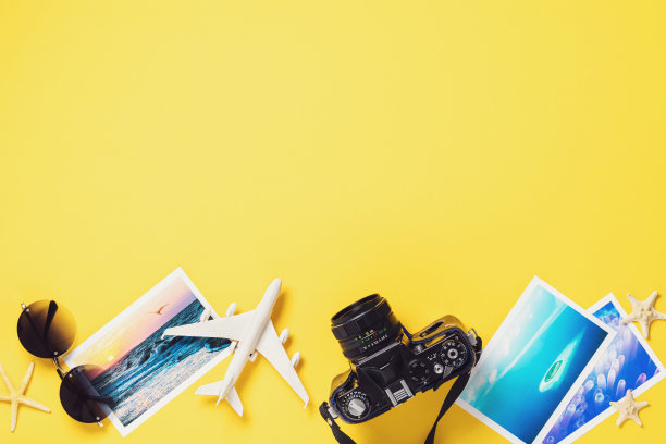 玩具飞机，眼镜，照片和相机在彩色纸背景与复制空间。旅游的概念图片下载