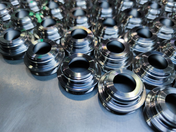 闪亮的不锈钢部件。一个边缘的金属数控车削生产批量铺仓排在平整的铁表面。图片下载