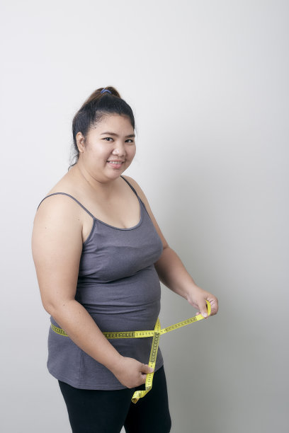 微笑的女人的肖像拿着卷尺白色的背景图片下载