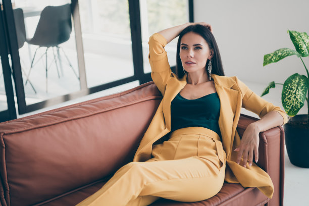 上面的高角度照片华丽的女士自由职业者躺在棕色的皮沙发在房子般的办公室享受她的美丽想吸引百万富翁男子在室内黄色昂贵的西装图片下载