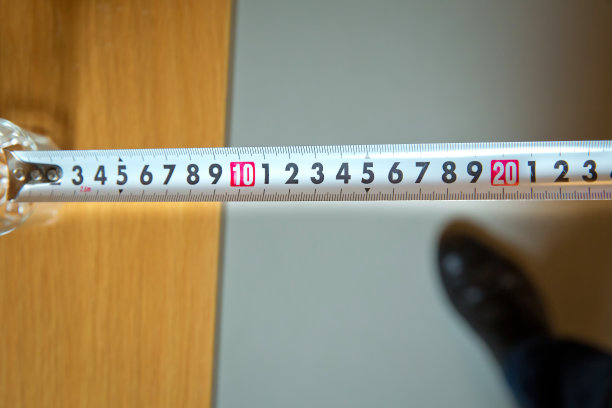 测量工具。卷尺。白色的轮盘赌。用米制刻度的木匠卷尺。艺术设计轮盘模板。老式折叠垃圾钢尺。图片下载