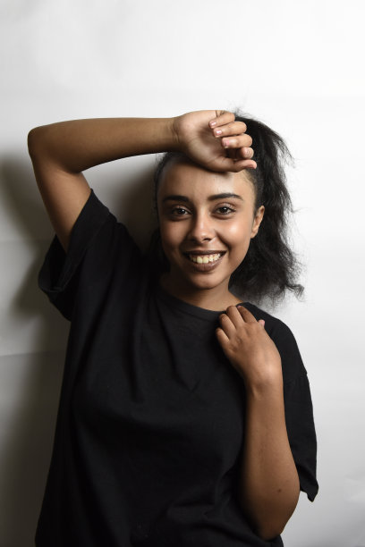 有着一头黑发的中东年轻女子。室内照片的精彩女模特在白色的背景。图片下载