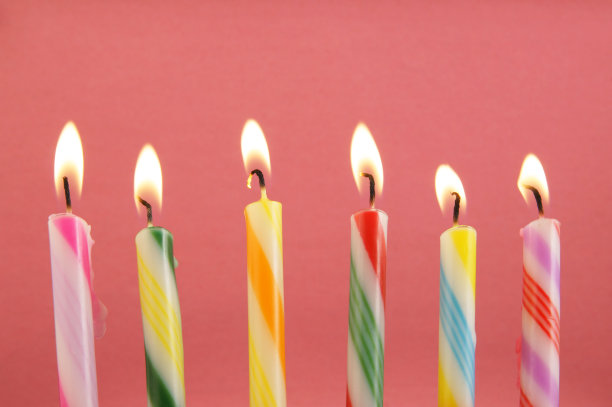 粉红色背景上的彩色生日蜡烛图片下载