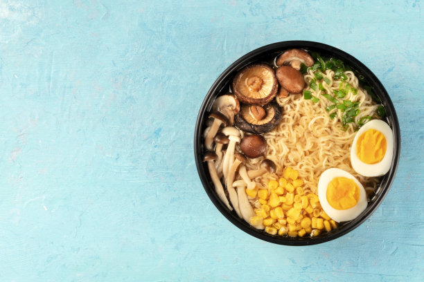 拉面。鸡蛋、香菇和金针菇、玉米和大葱荞麦面，上面的照片是蓝色背景，上面有文字图片下载