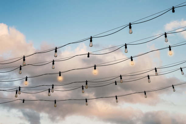 电灯泡和蓝天挂在电线上闪闪发光图片下载