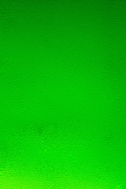 纹理水滴在啤酒瓶上。下降的背景。图片下载