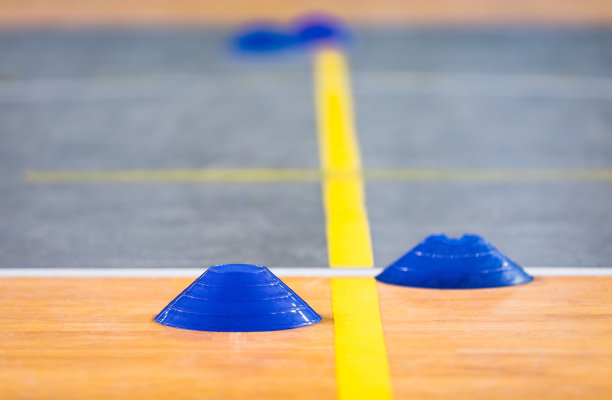 球场黄色边线上的足球室内标记。蓝色足球标志图片下载