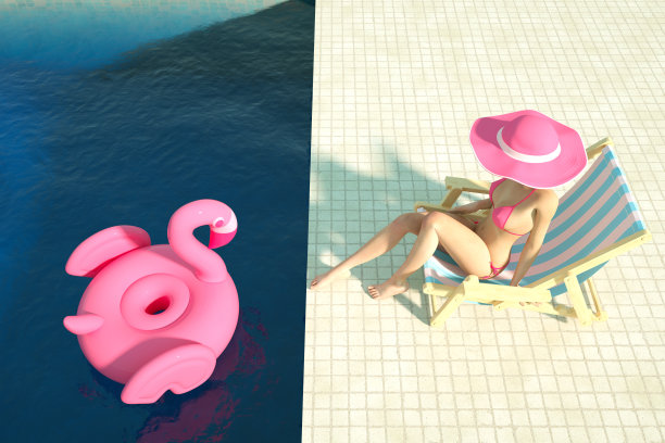 性感的女孩在一个粉红色的比基尼日光浴在游泳池，夏天的概念图片下载