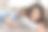 年轻的母亲微笑着躺在沙发上，女儿躺在她的背上。图片下载
